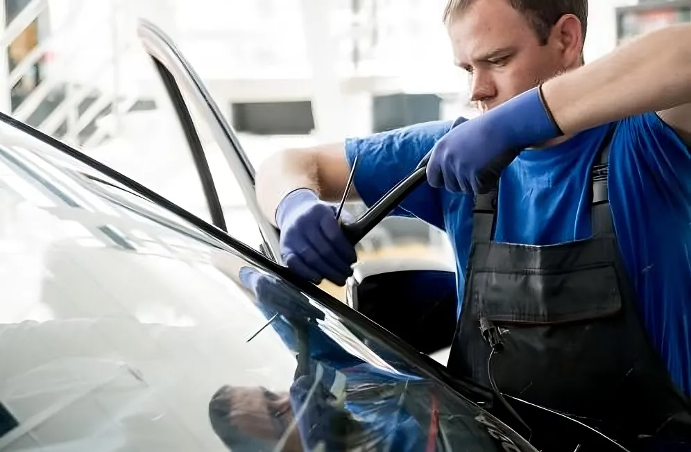 Technician finishing a windscreen fitting